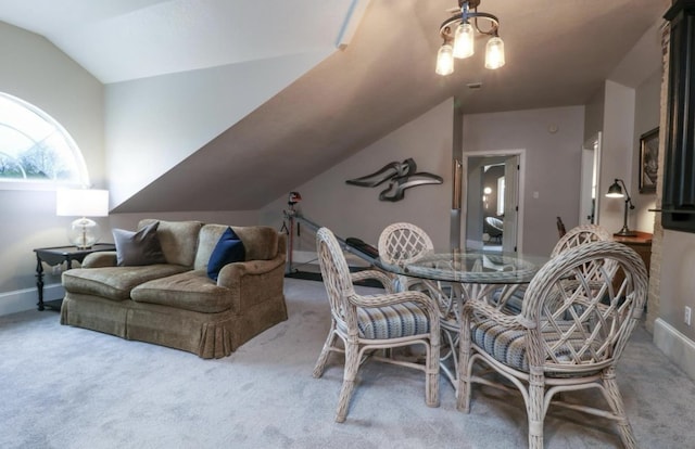 carpeted dining space with lofted ceiling