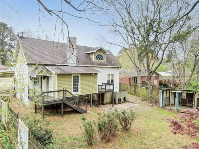 back of house featuring a wooden deck