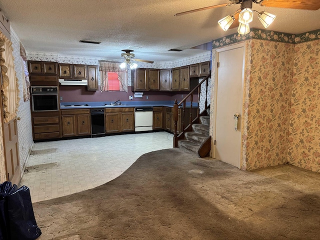 kitchen featuring dark brown cabinets, white dishwasher, black oven, and a textured ceiling