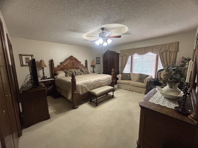 carpeted bedroom featuring a textured ceiling and ceiling fan