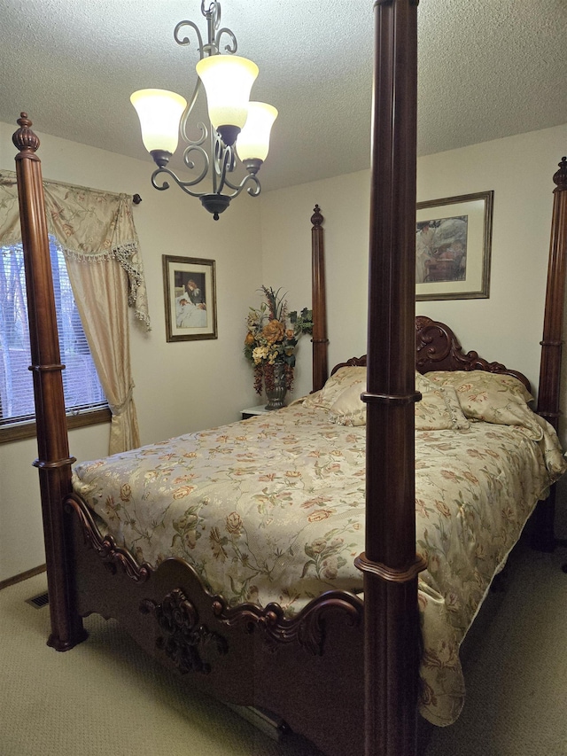 carpeted bedroom with a chandelier and a textured ceiling