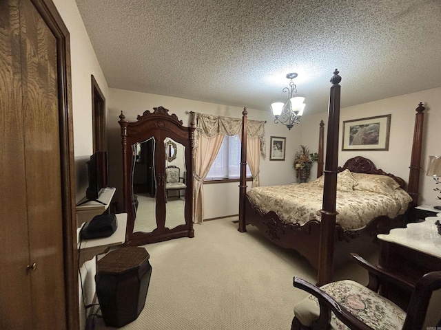 bedroom featuring a textured ceiling, light colored carpet, and a notable chandelier