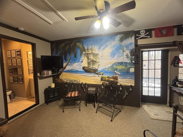 interior space with ceiling fan and crown molding