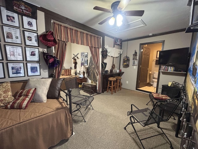 carpeted bedroom with ornamental molding and connected bathroom