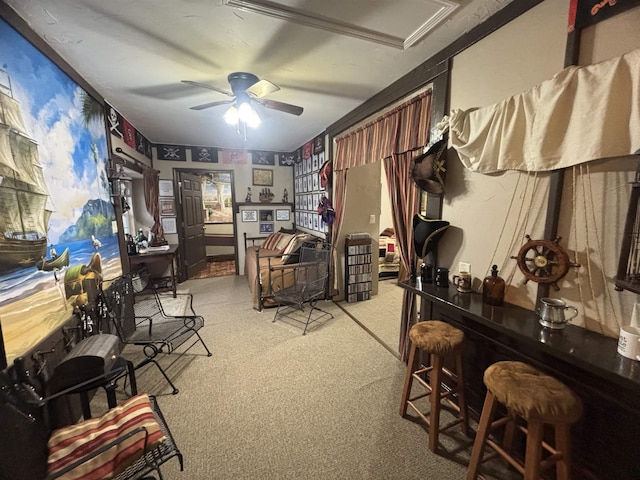 office space featuring ceiling fan, indoor bar, and light colored carpet