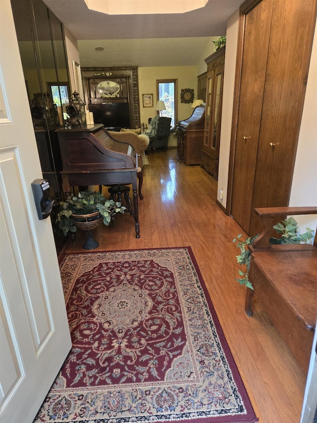 corridor featuring vaulted ceiling and hardwood / wood-style floors