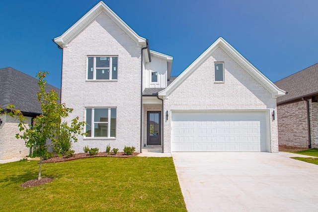 view of front of home with a front yard and a garage