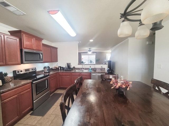 kitchen featuring light tile patterned flooring, sink, ornamental molding, appliances with stainless steel finishes, and ceiling fan