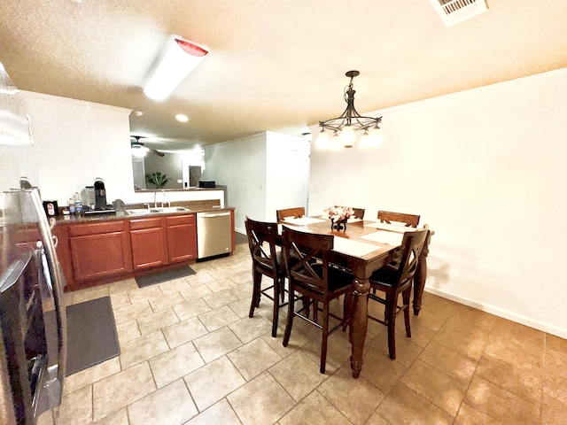 tiled dining space with sink and a textured ceiling