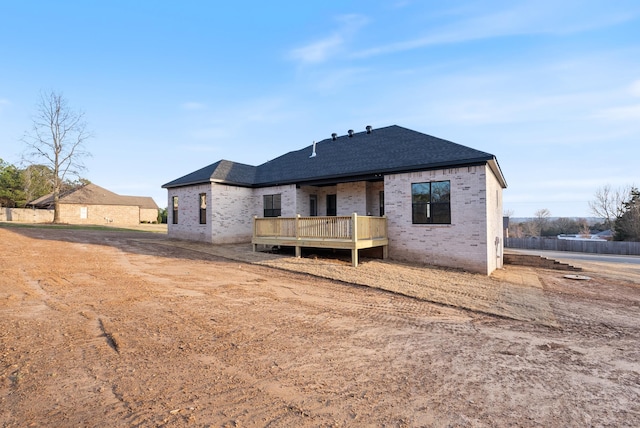 rear view of house with a wooden deck