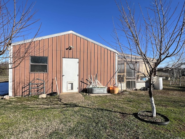 view of outbuilding featuring a lawn