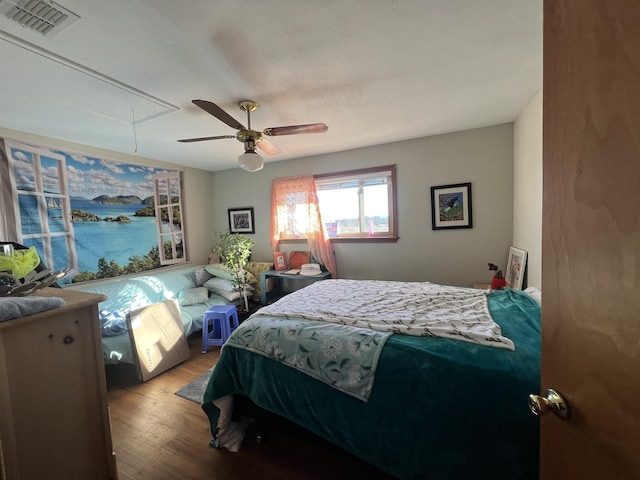 bedroom with ceiling fan and hardwood / wood-style flooring