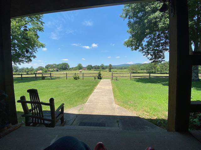 view of yard with a rural view and a patio