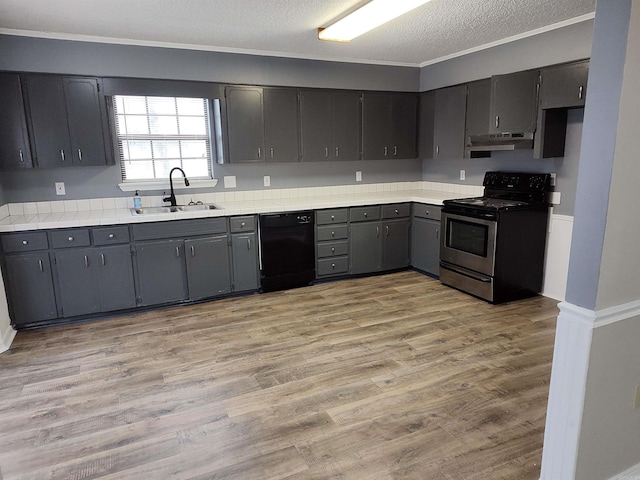 kitchen with a textured ceiling, black dishwasher, sink, gray cabinets, and range with electric cooktop