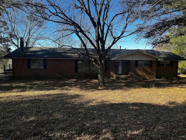 rear view of house with a yard