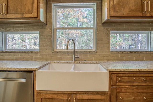 kitchen with sink, backsplash, dishwasher, and a healthy amount of sunlight