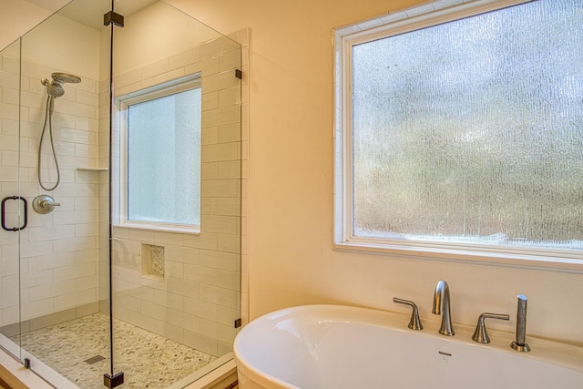 bathroom with independent shower and bath and a wealth of natural light