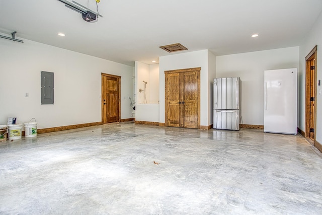 garage featuring electric panel, white fridge, and a garage door opener