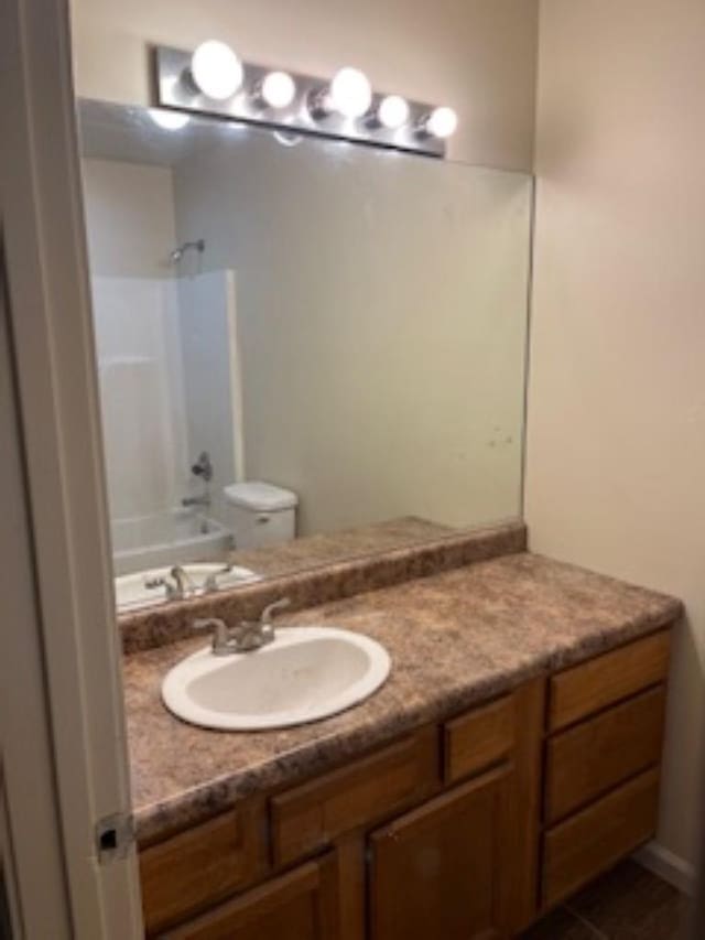 full bathroom with vanity, toilet, tile patterned floors, and tub / shower combination