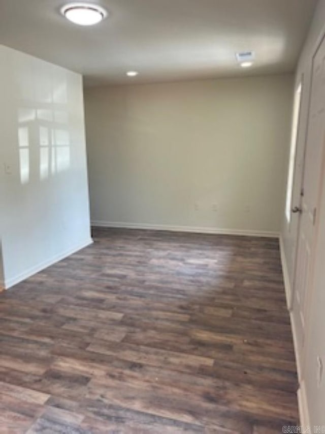 spare room featuring dark hardwood / wood-style floors