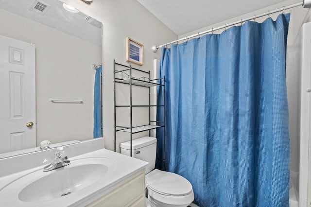 full bathroom featuring toilet, a textured ceiling, vanity, and shower / tub combo with curtain