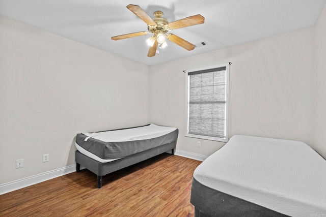 bedroom with ceiling fan and light hardwood / wood-style floors