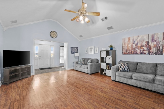 living room with ceiling fan, hardwood / wood-style floors, ornamental molding, and vaulted ceiling