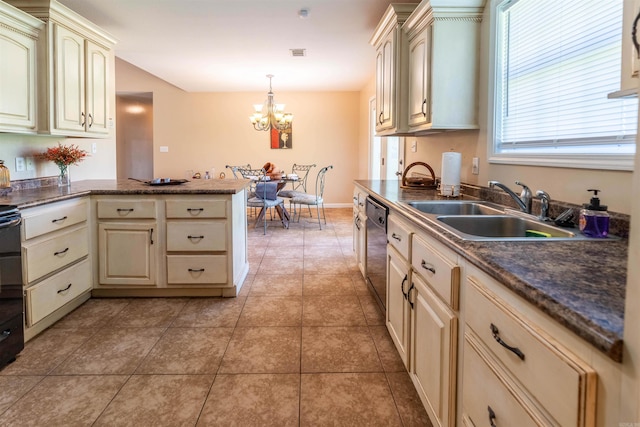 kitchen featuring light tile patterned floors, sink, cream cabinetry, and decorative light fixtures