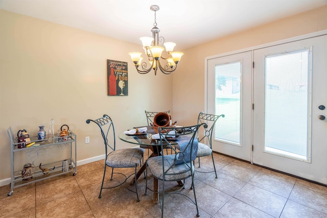 tiled dining area featuring a healthy amount of sunlight and a chandelier