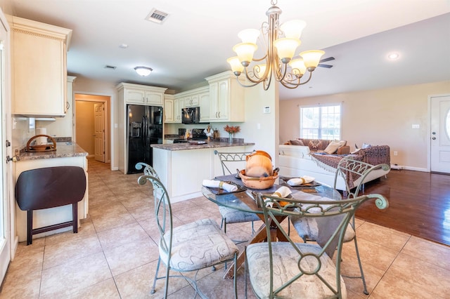 dining room featuring a notable chandelier and light tile patterned flooring