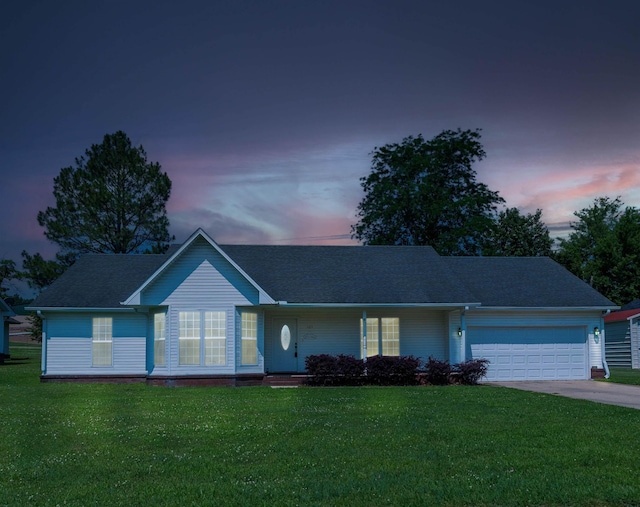 single story home with a garage, a front yard, and concrete driveway