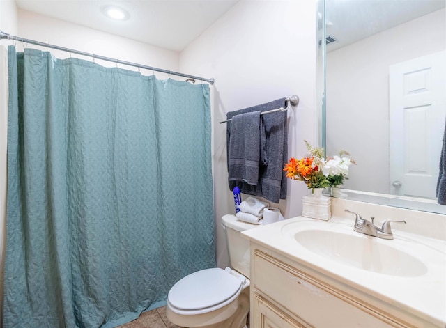 bathroom featuring toilet, tile patterned floors, and vanity