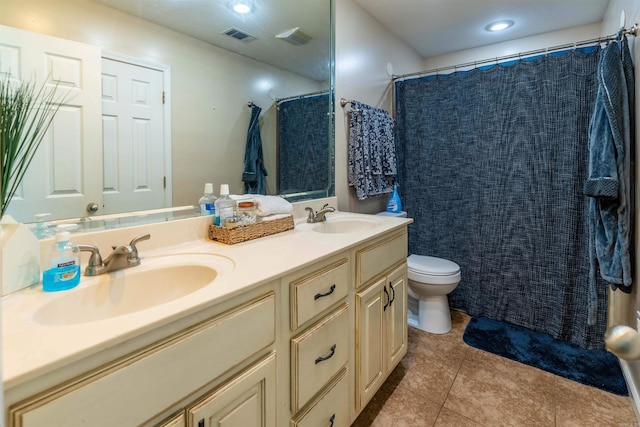 bathroom featuring toilet, vanity, tile patterned floors, and curtained shower