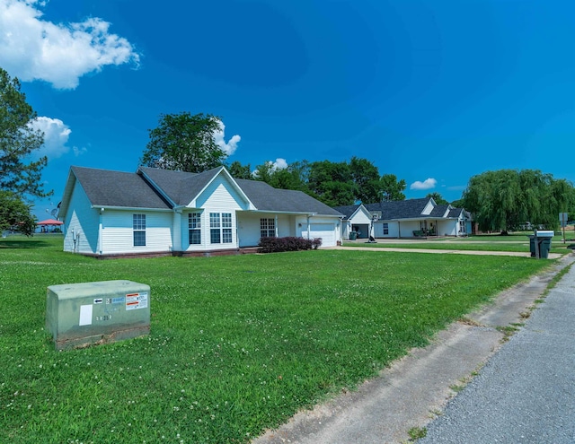 ranch-style house featuring a front yard and a garage