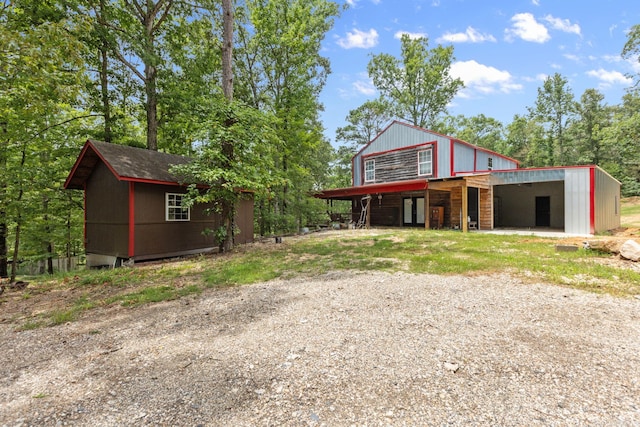 view of front facade featuring an outbuilding and a carport