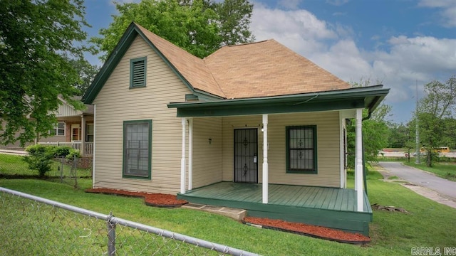 exterior space featuring a lawn and covered porch