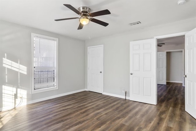 unfurnished room featuring ceiling fan and dark hardwood / wood-style flooring