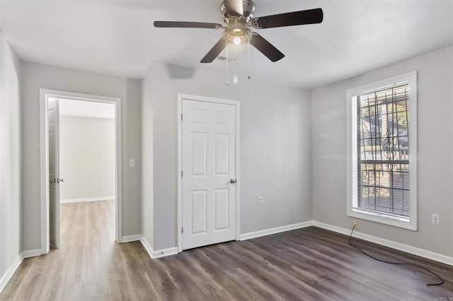 unfurnished bedroom with ceiling fan and hardwood / wood-style flooring