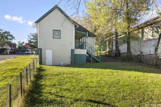 rear view of house featuring a yard