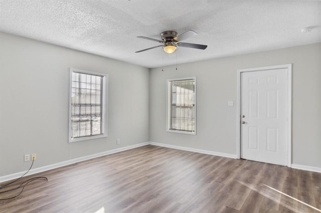 unfurnished room featuring a textured ceiling, ceiling fan, and hardwood / wood-style flooring