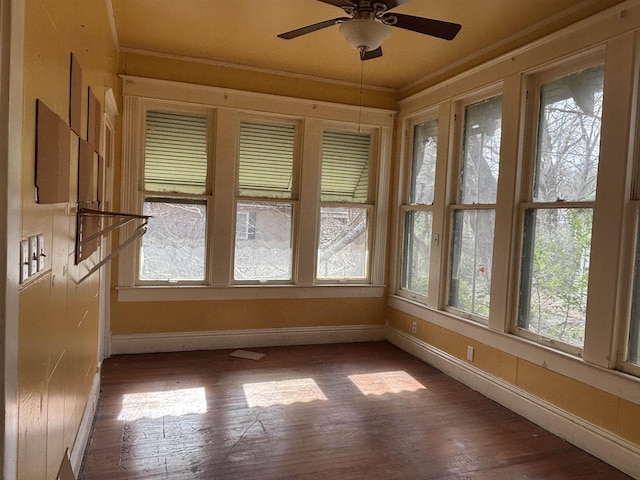 unfurnished sunroom with ceiling fan