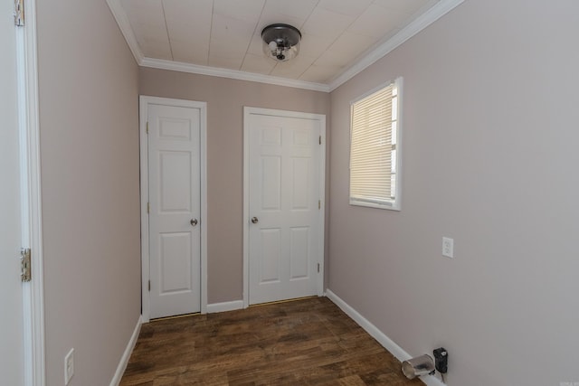 corridor featuring dark hardwood / wood-style floors and crown molding