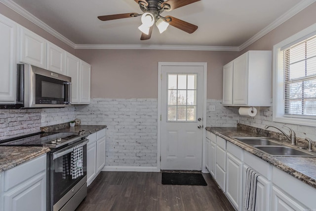 kitchen featuring sink, white cabinetry, ornamental molding, stainless steel appliances, and dark hardwood / wood-style flooring