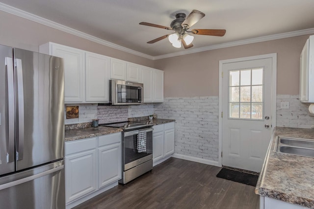 kitchen with white cabinets, dark hardwood / wood-style flooring, stainless steel appliances, sink, and crown molding