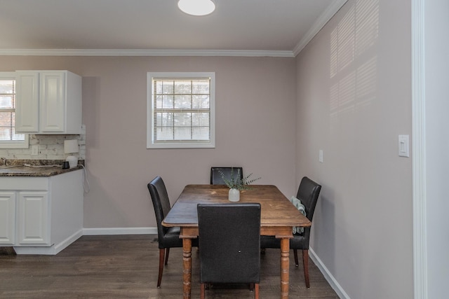 dining room with dark hardwood / wood-style floors and ornamental molding