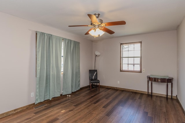 unfurnished room featuring ceiling fan and dark hardwood / wood-style floors