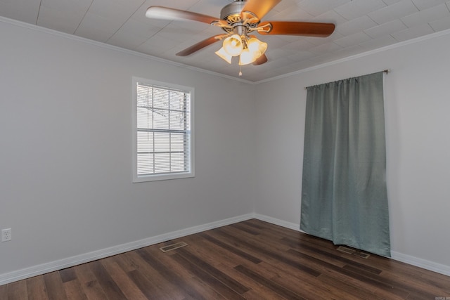 empty room with ceiling fan, dark hardwood / wood-style flooring, and crown molding