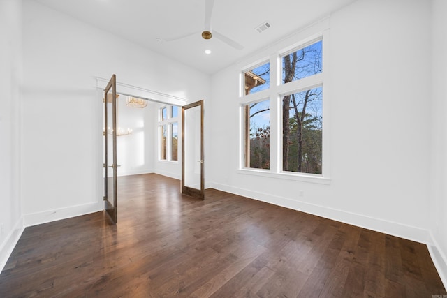 empty room featuring ceiling fan and dark hardwood / wood-style flooring