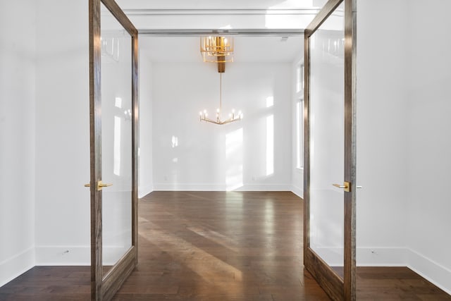 interior space with an inviting chandelier and dark wood-type flooring