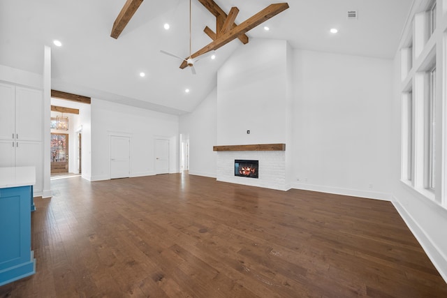 unfurnished living room with beamed ceiling, dark hardwood / wood-style flooring, ceiling fan, and high vaulted ceiling